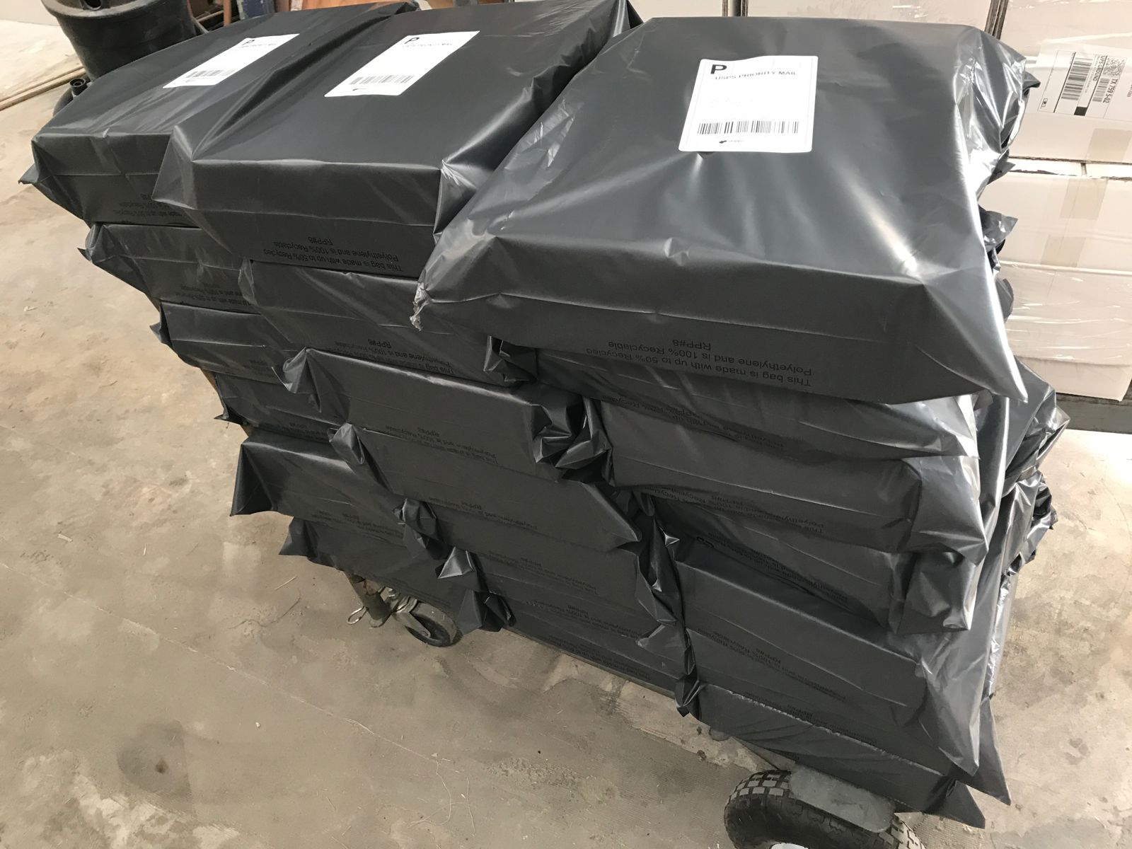 Poly-bagged orders stacked and labeled for outbound shipping