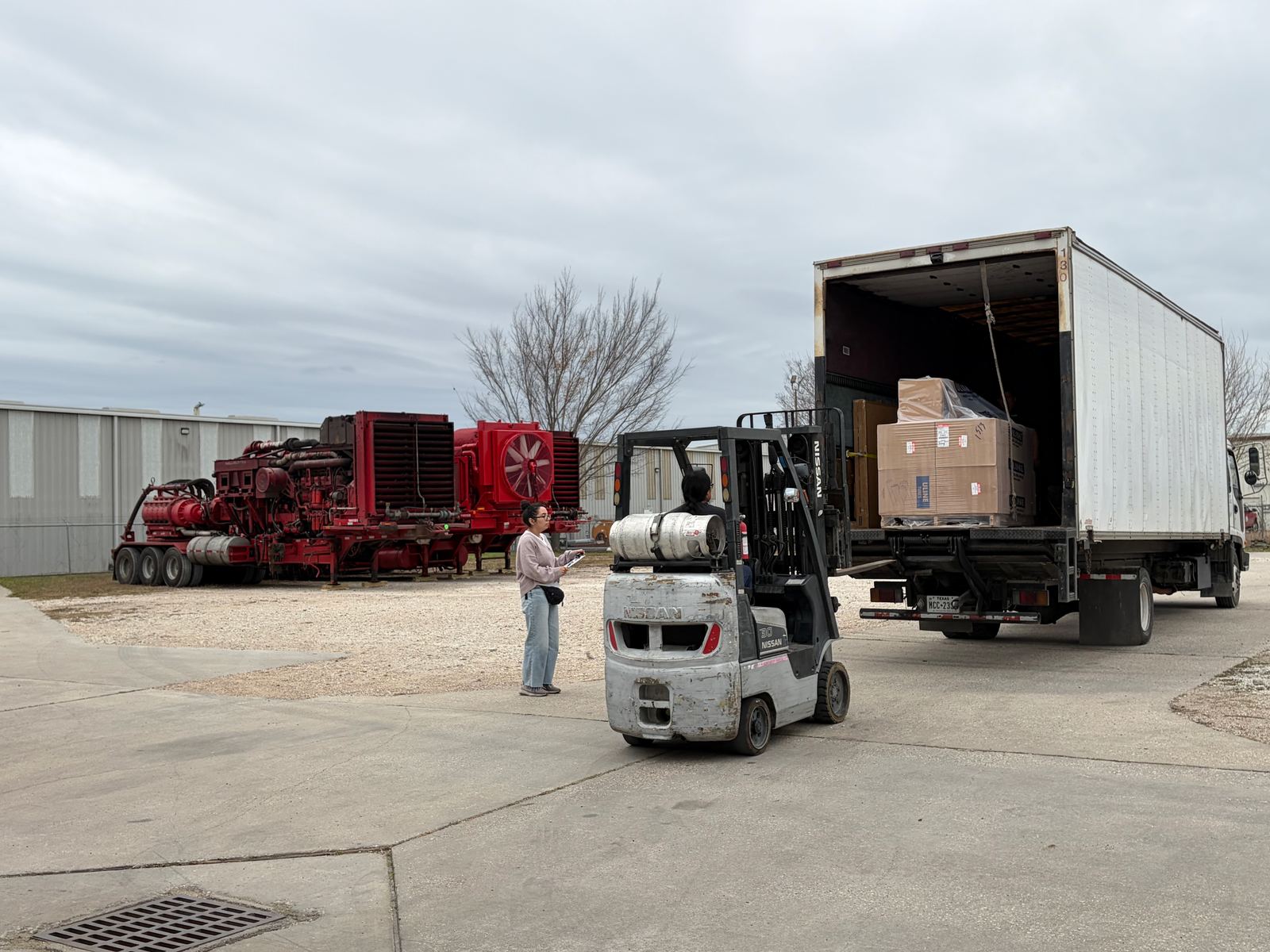 Forklift unloading palletized freight from a trailer at FlexPrep