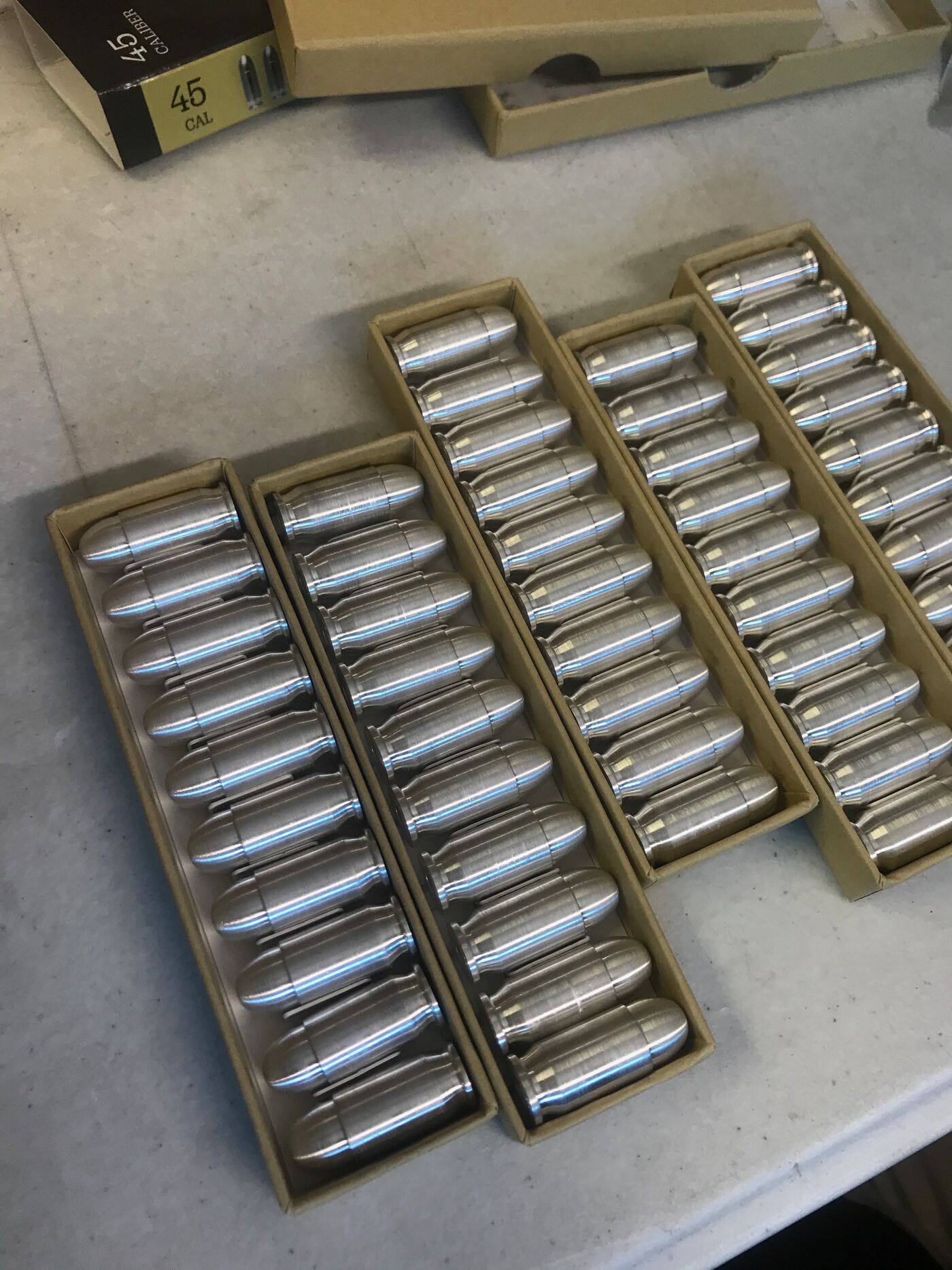 Trays of machined silver bullets — real silver, inert replica ammunition — inspected and kitted at FlexPrep