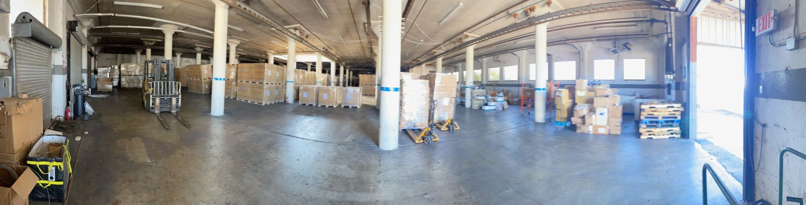 Wide view of FlexPrep's warehouse floor stacked with palletized inventory